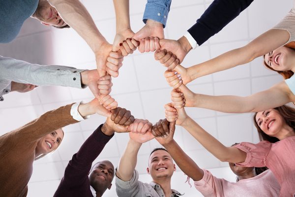 Multi-ethnic Group Of People Holding Each Other Thumbs Forming Circle