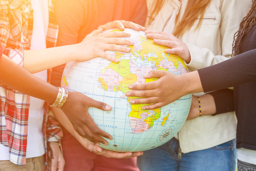 Group of Teenagers Holding World Globe Map
